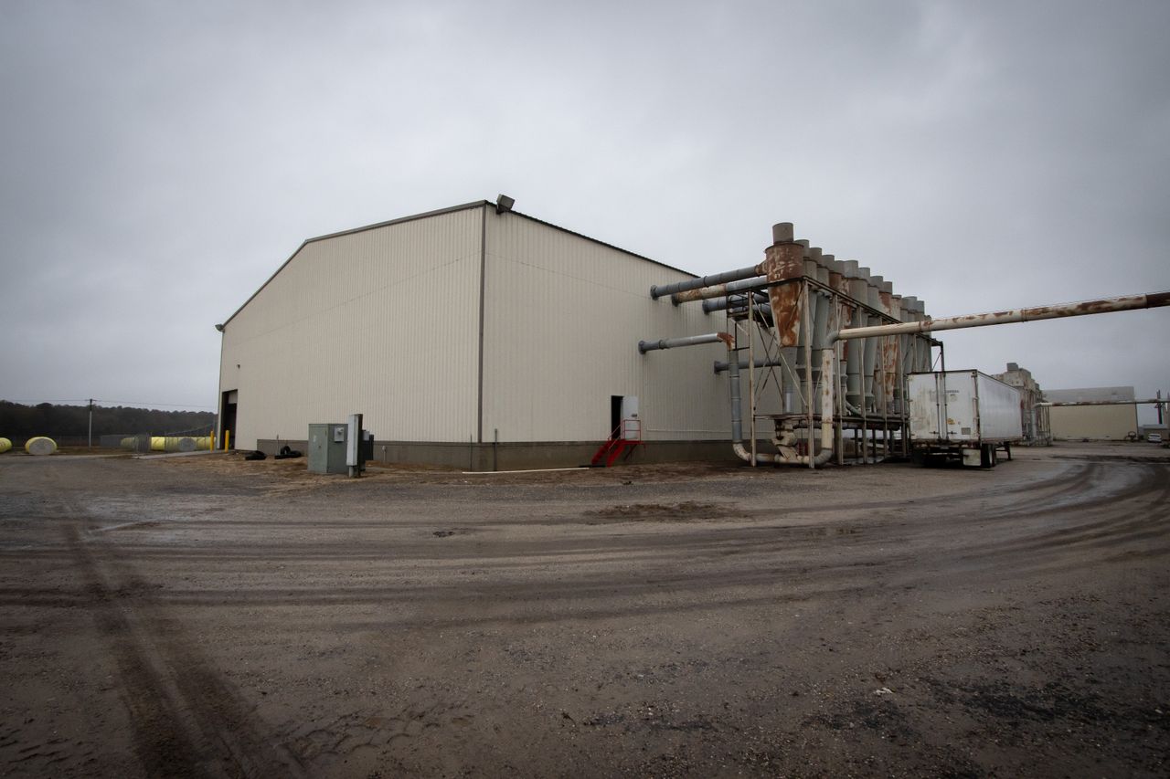 About Large industrial warehouse with attached pipes in a rural setting, North Carolina.